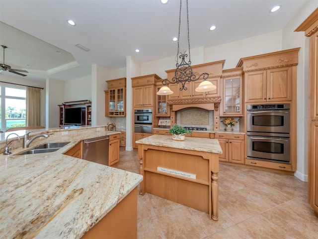 kitchen with tasteful backsplash, hanging light fixtures, appliances with stainless steel finishes, sink, and a center island