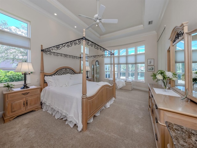 carpeted bedroom featuring multiple windows, ornamental molding, a high ceiling, and ceiling fan