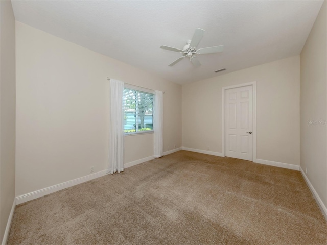 carpeted empty room featuring ceiling fan