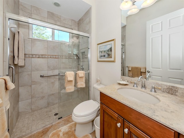 bathroom featuring vanity, tile patterned floors, toilet, and an enclosed shower