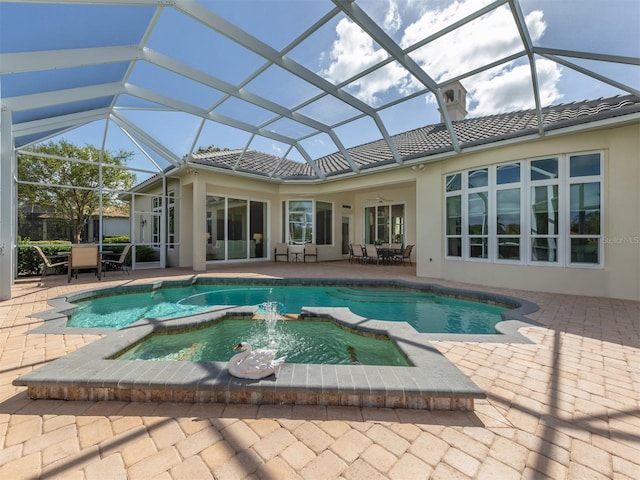 view of swimming pool with a patio, an in ground hot tub, and glass enclosure