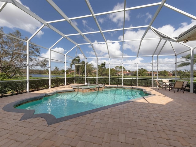 view of pool with a patio, a lanai, and an in ground hot tub