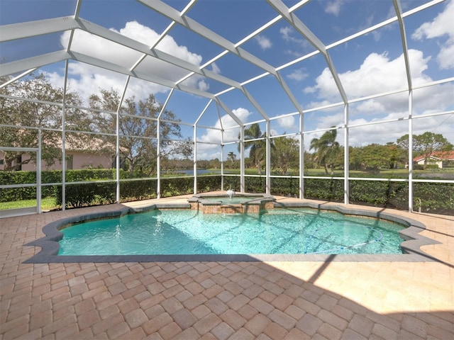 view of swimming pool featuring an in ground hot tub, a patio, and a lanai