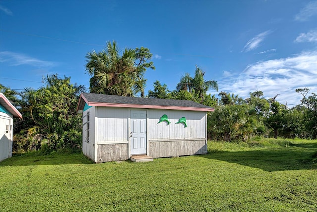 view of outbuilding with a lawn