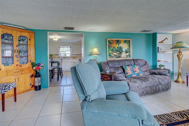living area with light tile patterned flooring and visible vents