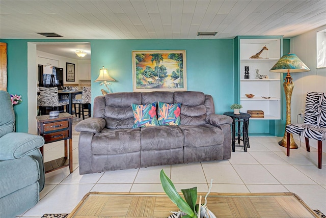 living room with tile patterned floors and wooden ceiling