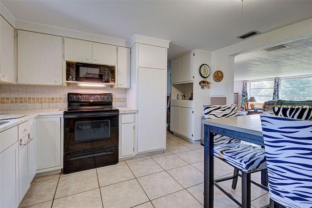 kitchen with black appliances, white cabinets, tasteful backsplash, and light tile patterned floors