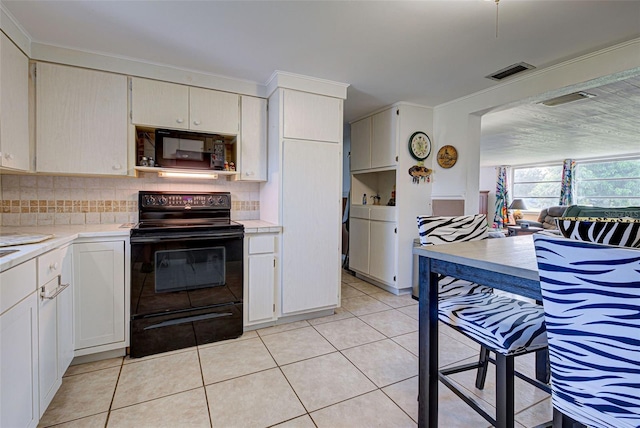 kitchen with visible vents, light countertops, black appliances, and tasteful backsplash