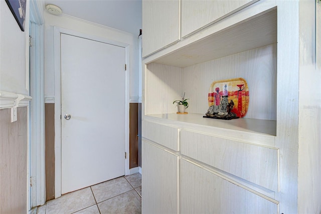interior space with light tile patterned floors and light countertops