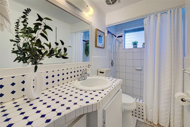 full bathroom with visible vents, tile walls, vanity, toilet, and a shower with shower curtain