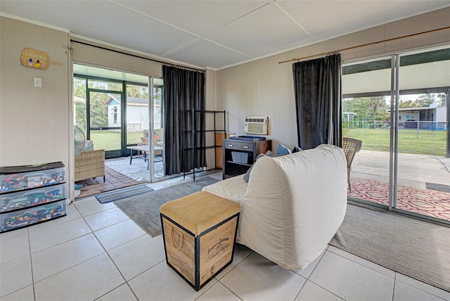 living room featuring an AC wall unit and tile patterned floors