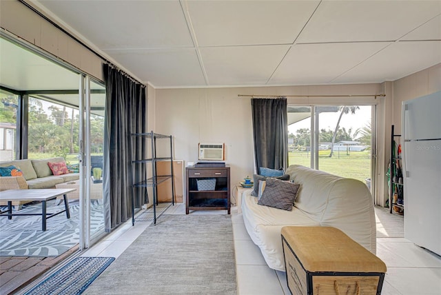 living room with light tile patterned flooring and a wall unit AC