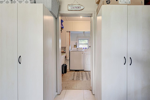 hall featuring washer and clothes dryer and light tile patterned floors