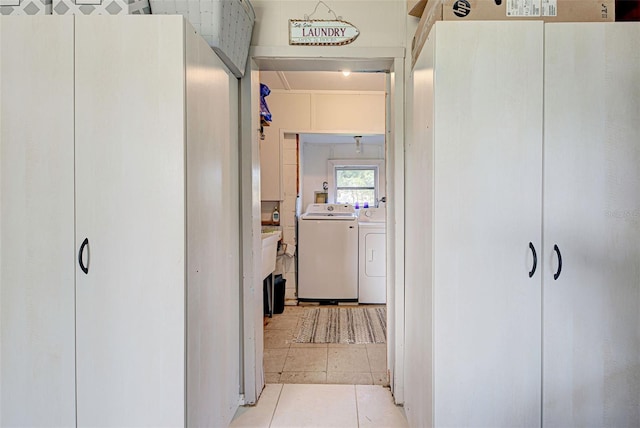corridor with washing machine and clothes dryer and tile patterned flooring