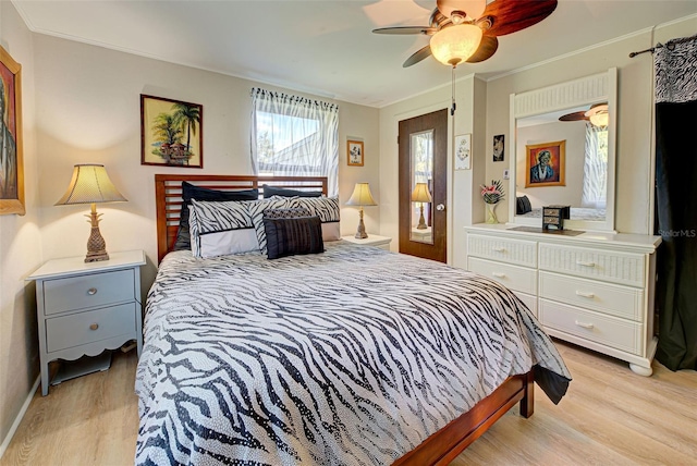 bedroom featuring a ceiling fan, baseboards, ornamental molding, and light wood-style floors