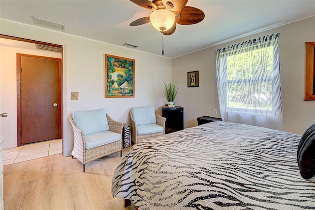 bedroom with crown molding and visible vents