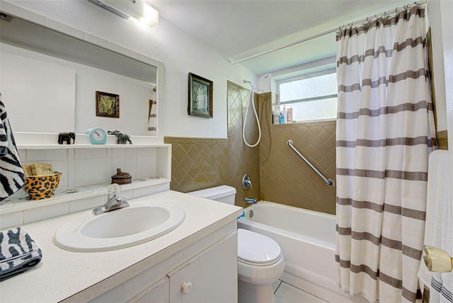 full bathroom featuring shower / bath combo, toilet, tile patterned flooring, vanity, and tile walls