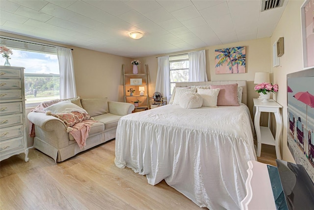 bedroom featuring visible vents and light wood-style flooring