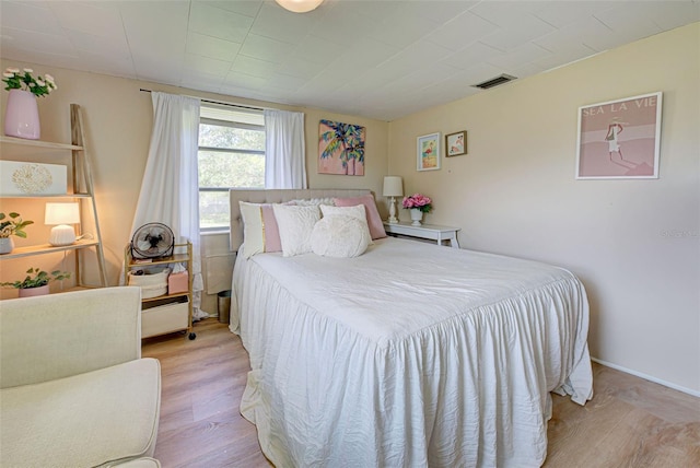 bedroom featuring visible vents and light wood-style floors