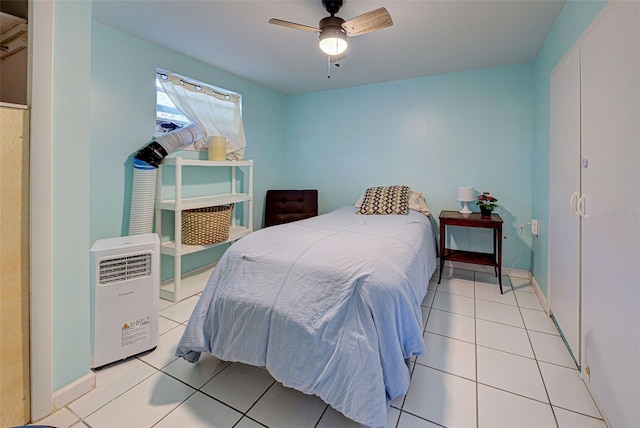 tiled bedroom featuring ceiling fan