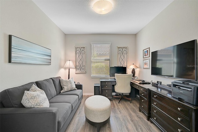 office space featuring light hardwood / wood-style flooring and a textured ceiling