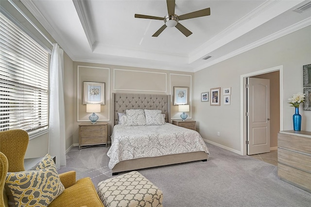 bedroom with a raised ceiling, light carpet, and ceiling fan