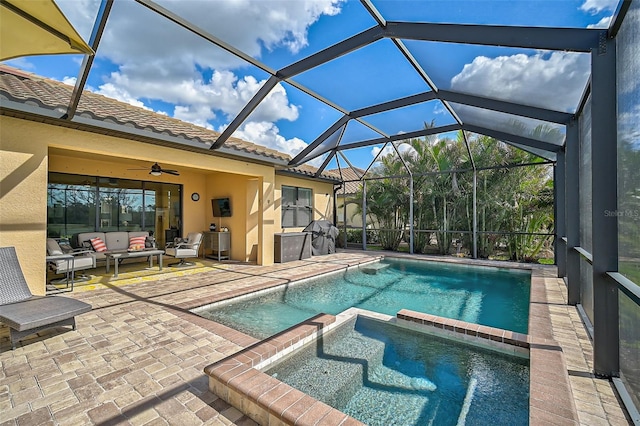 view of pool with a lanai, ceiling fan, a patio area, an outdoor hangout area, and an in ground hot tub