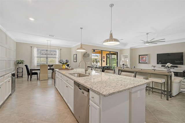 kitchen with a kitchen island with sink, a sink, white cabinets, dishwasher, and pendant lighting