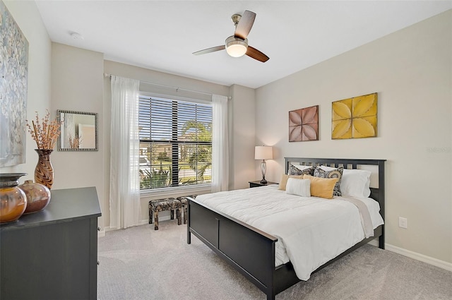 bedroom featuring ceiling fan, baseboards, and light colored carpet