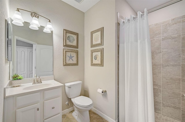 bathroom with toilet, a stall shower, vanity, tile patterned flooring, and baseboards