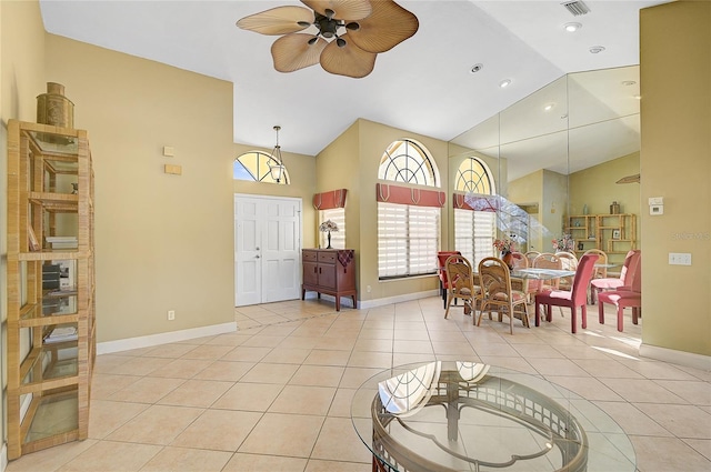 tiled dining space featuring high vaulted ceiling and ceiling fan