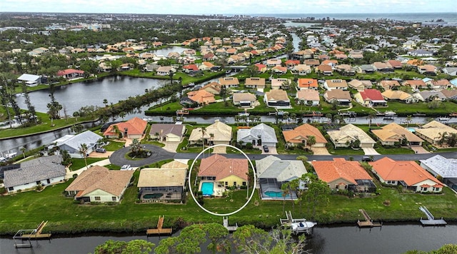 birds eye view of property with a water view