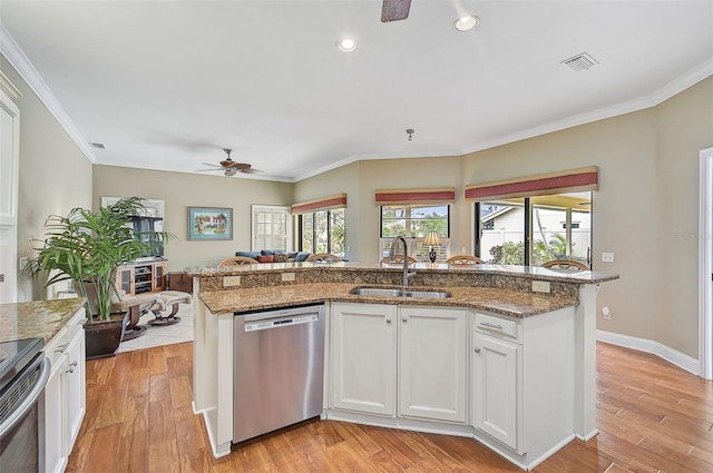 kitchen with white cabinetry, sink, appliances with stainless steel finishes, and light hardwood / wood-style flooring