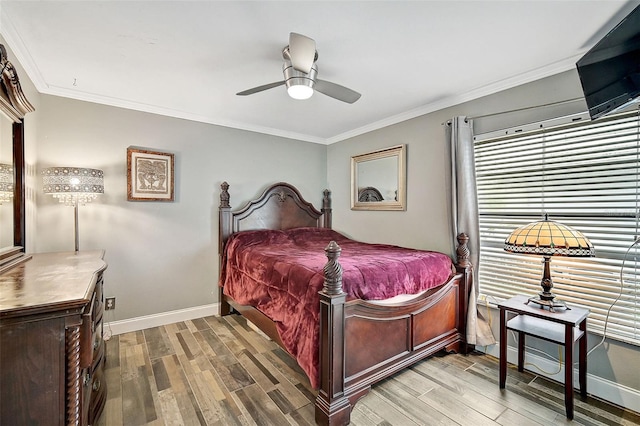 bedroom featuring hardwood / wood-style flooring, ceiling fan, and ornamental molding