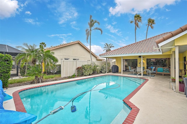 view of swimming pool featuring a patio and ceiling fan