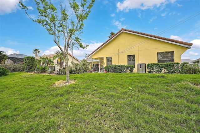 rear view of property with a yard