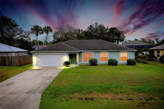 single story home featuring a yard and a garage