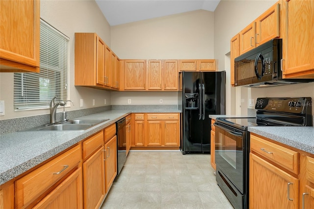 kitchen with sink, black appliances, and lofted ceiling