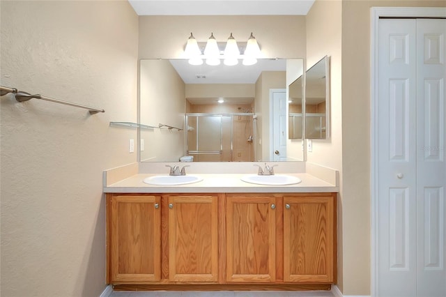 bathroom featuring vanity and a shower with shower door