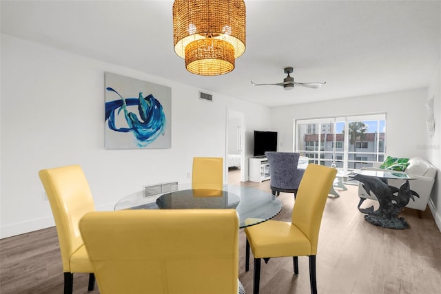 dining space featuring hardwood / wood-style floors and ceiling fan