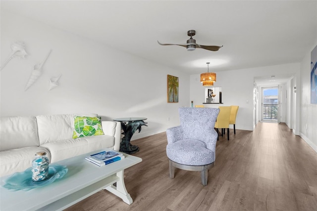 living room featuring hardwood / wood-style floors and ceiling fan