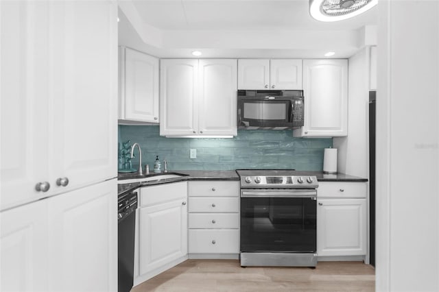 kitchen featuring white cabinets, light hardwood / wood-style flooring, black appliances, and sink