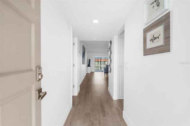 corridor with light wood-type flooring