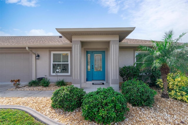 view of exterior entry with a garage