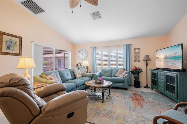 tiled living room with a wealth of natural light, vaulted ceiling, and ceiling fan