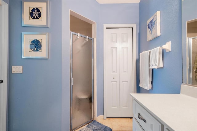 bathroom with vanity, tile patterned flooring, and an enclosed shower