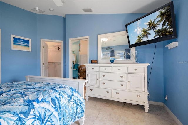 bedroom featuring ceiling fan, light tile patterned floors, a spacious closet, vaulted ceiling, and a closet