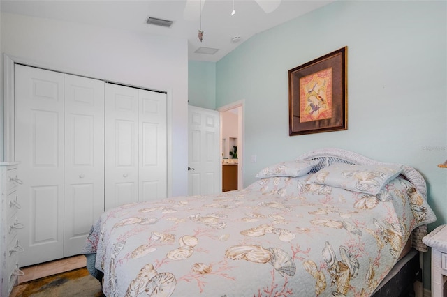 bedroom with dark colored carpet, a closet, lofted ceiling, and ceiling fan