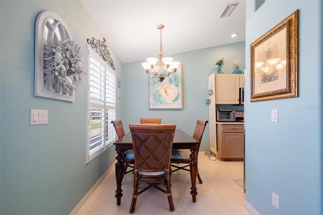 dining area featuring lofted ceiling, light tile patterned flooring, and a notable chandelier