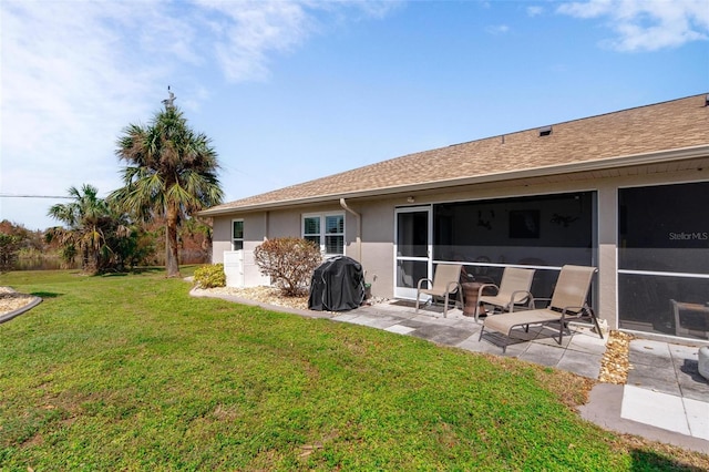 back of house featuring a patio, a yard, and a sunroom